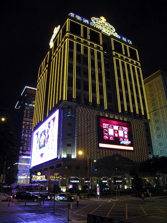 High-rise hotel facade outlined with warm linear LED lines enhancing architectural edges at night