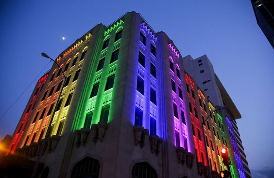 Historic building with colorful wash lighting creating vertical color bands on the facade after dusk