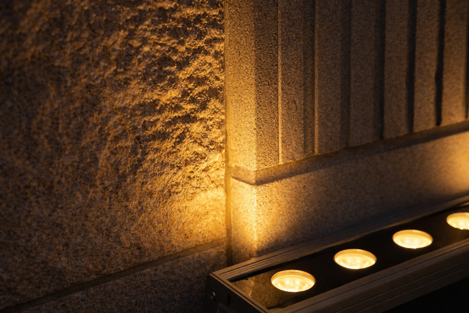 close-up of LED wall washer beam on textured facade showing uniform gradation